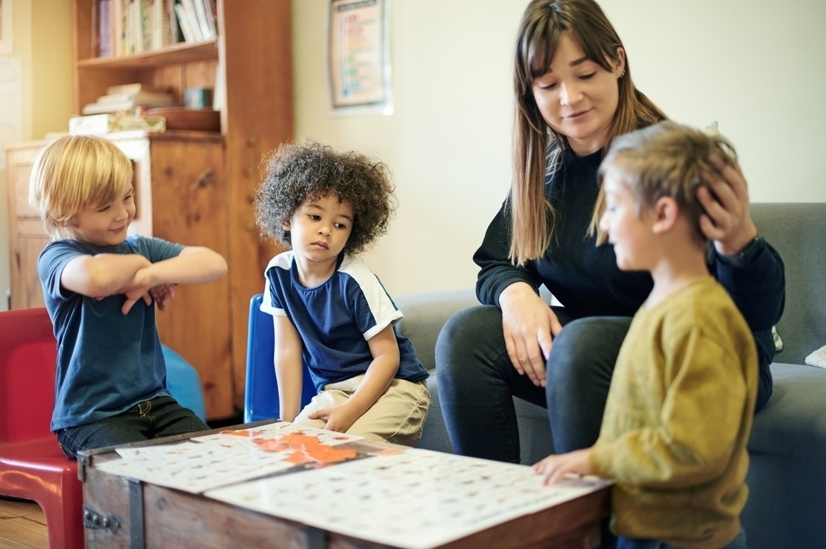 A therapist guiding young children through structured activities as part of autism therapy options for children