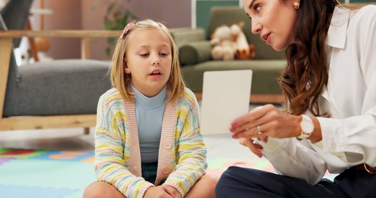 A young girl receiving autism treatment in Las Vegas during a one-on-one therapy session with a clinician
